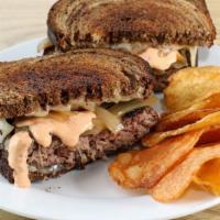 Grilled Patty Melt · Beef Patty with Swiss Cheese, Caramelized Onions, and Mak Sauce on Toasted Marble Rye Bread.