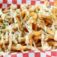 Truffle Fries · Classic fries Served with Truffle Aioli and  Parmesan Cheese.