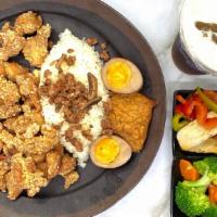 Salty Fried Chicken Rice 鹽酥雞飯 · Salty fried chicken served with asian salad, tea egg and tofu on the side and meat sauce ove...