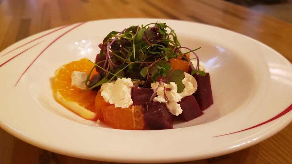 Beets Salad · Roasted beets, citrus, goat cheese, shaved onions, hazelnuts.