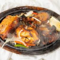 Tandoori Chicken · Half chicken on bone, marinade in tandoor herbs and spices.