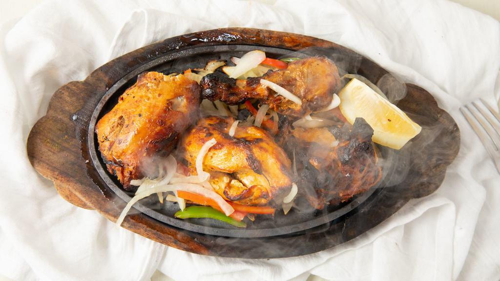 Tandoori Chicken · Half chicken on bone, marinade in tandoor herbs and spices.