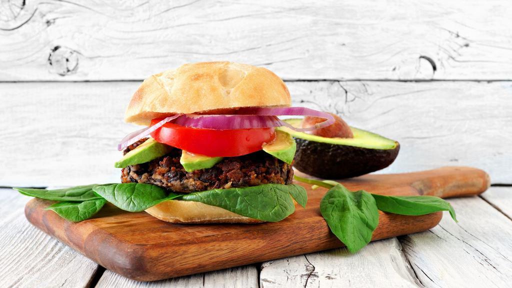 Veggie Burger · Mouthwatering Veggie Burger topped with lettuce, tomato, and onion.