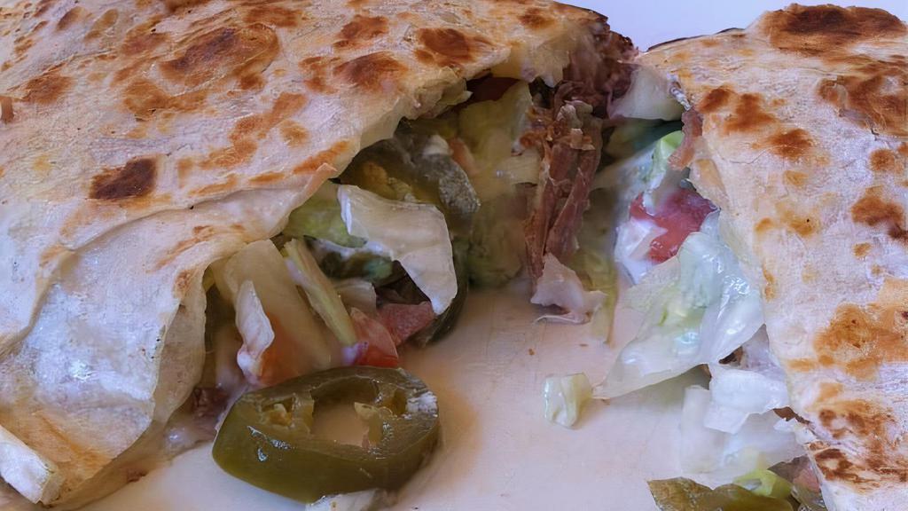 Super Quesadilla / Super Quesadilla · Lechuga, tomate, queso, crema agria, aguacate, jalapeño y carne a elección. / Lettuce, tomatoes, cheese, sour cream, avocado, jalapeno and choice of meat.