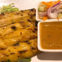 Satay Chicken  · Grilled skewered strips of marinated chicken breast. Served with peanut curry sauce and cucu...
