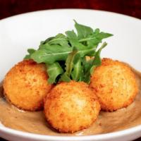 Taleggio Stuffed Arancini · Warm Arborio Rice Balls, Filled with Taleggio Cheese,
Served with Black Garlic Aioli