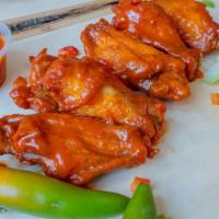 Famous Bone-In Buffalo Wings · Served with carrot & celery.