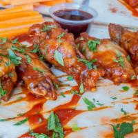 Famous Bone-In BBQ Wings · Served with carrot & celery.