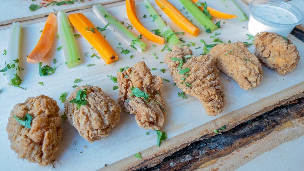 Famous Bone-Less Crispy Wings · Served with carrot & celery.