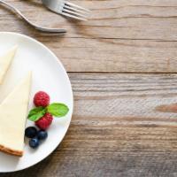 New York Cheesecake with a Pint Vanilla Ice Cream · A creamy and rich New York cheesecake sitting on a graham cracker base served with a pint of...