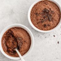 Mousse al Cioccolato · A chocolate sponge base topped with a dark chocolate mousse and dusted with cocoa powder.