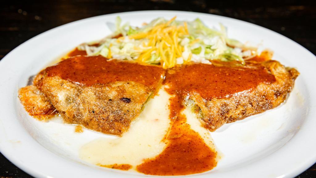 Chile Relleno · Roasted long green chile stuffed with montery jack cheese with a light egg batter, topped with mole (enchilada sauce), lettuce.