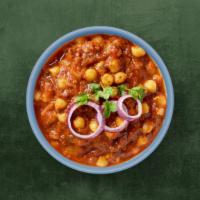 Spiced Chickpea Curry · Chickpeas slow cooked in a thick gravy made of chopped onions, tomatoes, and whole warm spic...