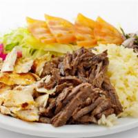 Combo Shawarma Plate · Savory chicken and beef, hummus, green salad, rice, and warm pita bread.