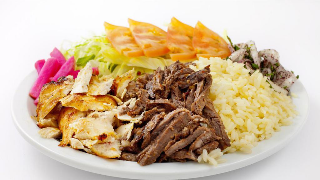 Combo Shawarma Plate · Savory chicken and beef, hummus, green salad, rice, and warm pita bread.