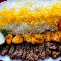 Mixed Grill Plate · Chicken and lamb shish kebabs, kofte kebab, hummus, green salad, rice, and warm pita bread.