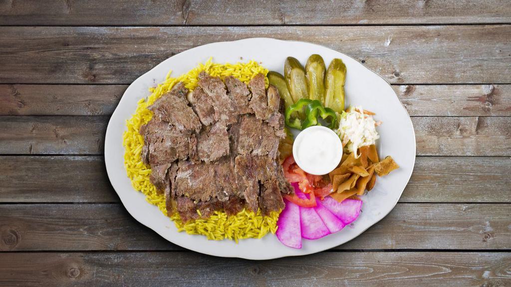 Beef Shawarma Plate · Tender beef, hummus, green salad, rice, and warm pita bread.
