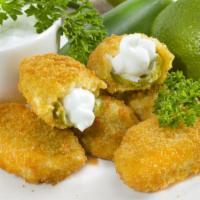 Jalapeno Poppers (6 Pc) · Crispy golden jalapenos stuffed with creamy cheese and served with savory marinara dipping s...