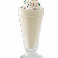Vanilla Shake · Creamy soft-serve blended with milk and vanilla syrup. Garnished with whipped cream and rain...