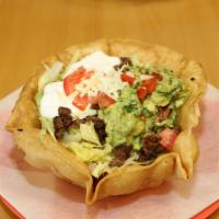 Tostada Salad · Flour tortilla bowl with rice, beans, choice of meat, lettuce, cheese, guacamole, sour cream...