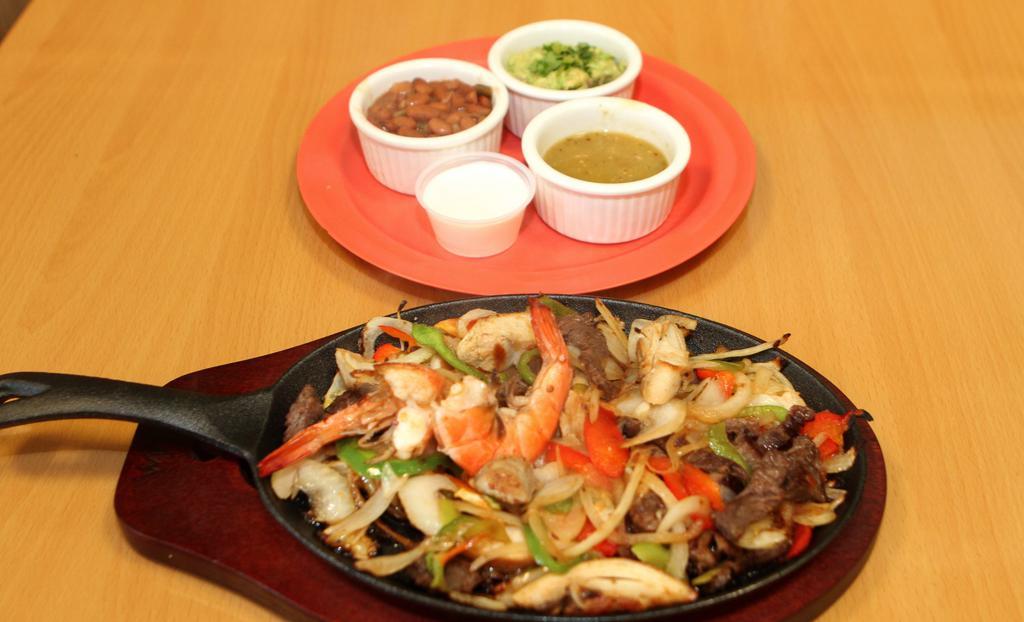 Sizzling Fajitas · Steak, chicken or shrimp with flour tortillas, pico de gallo, guacamole, sour cream, salsa, side of whole beans.
