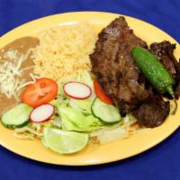 Carne Asada · Steak. Served with rice, beans and green salad.