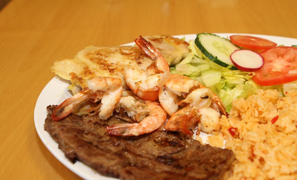 Cielo Mar Tierra · Camarones, carne y pollo a la parrilla. Grilled prawns, grilled steak and grilled chicken. Served with rice, beans and green salad.