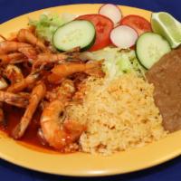 Camarones A La Diabla · Prawns in spicy red sauce. Served with rice, beans and green salad.