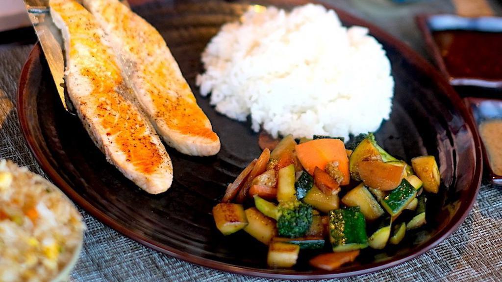 Salmon Hibachi · North Atlantic salmon filets cooked with lemon. . Served with white rice, seasonal vegetables, Ginger sauce, and Mustard sauce.