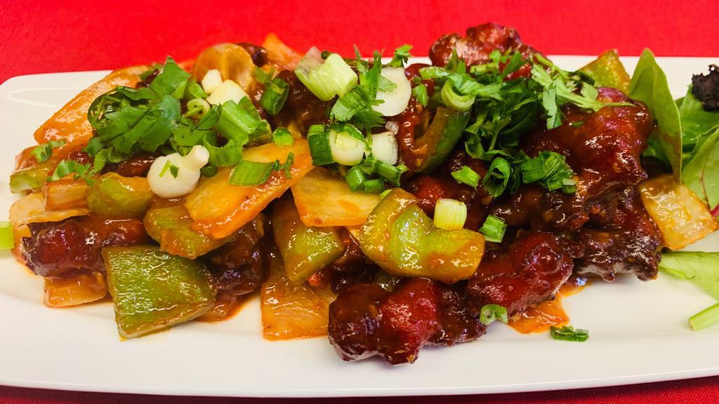 Chili Chicken · Marinate chicken cube deep fried and cooked with onion, bell pepper and manchurian sauce.