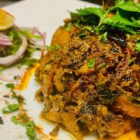 Goat Sukha · Tender meat cooked in onion, cilantro and fragrant spices.