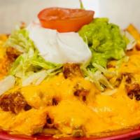 Nachos · Corn chips topped with cheese and mild sauce. Served with guacamole and sour cream.