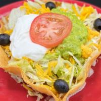 Taco Salad · Crisp bowl-shaped flour tortilla filled with chicken, ground beef, chile colorado or chile v...