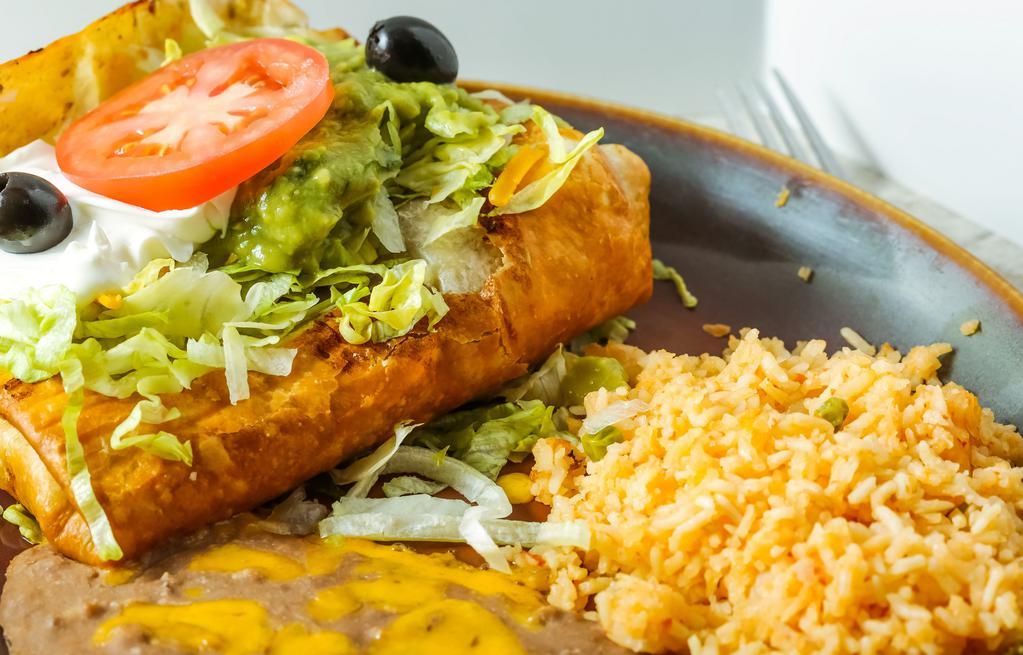 Chimichanga · A large flour tortilla filled with beef, chicken or pork. Deep fried and topped with guacamole, sour cream and sliced tomato.