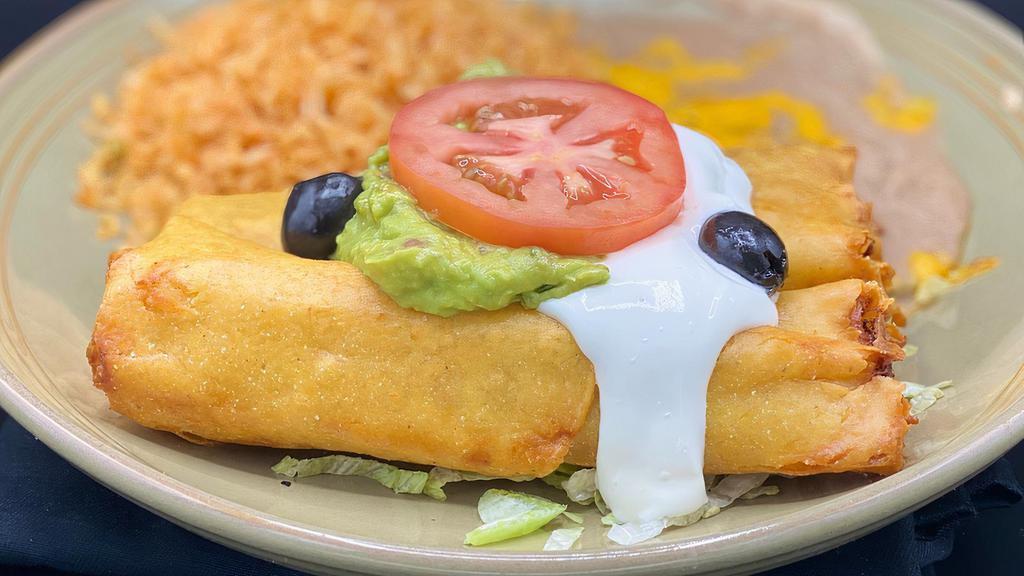 Flautas · Two crisp corn tortillas filled with shredded beef or chicken. Topped with guacamole and sour cream.