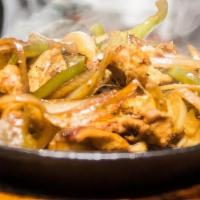 Fajitas · Thin strips of marinated steak, chicken or shrimp on a bed of grilled onions and bell pepper...