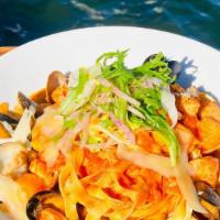Grand Seafood Linguini · Gulf shrimp, bay scallops, mussels, clams, salmon, calamari, tomatoes, white wine.