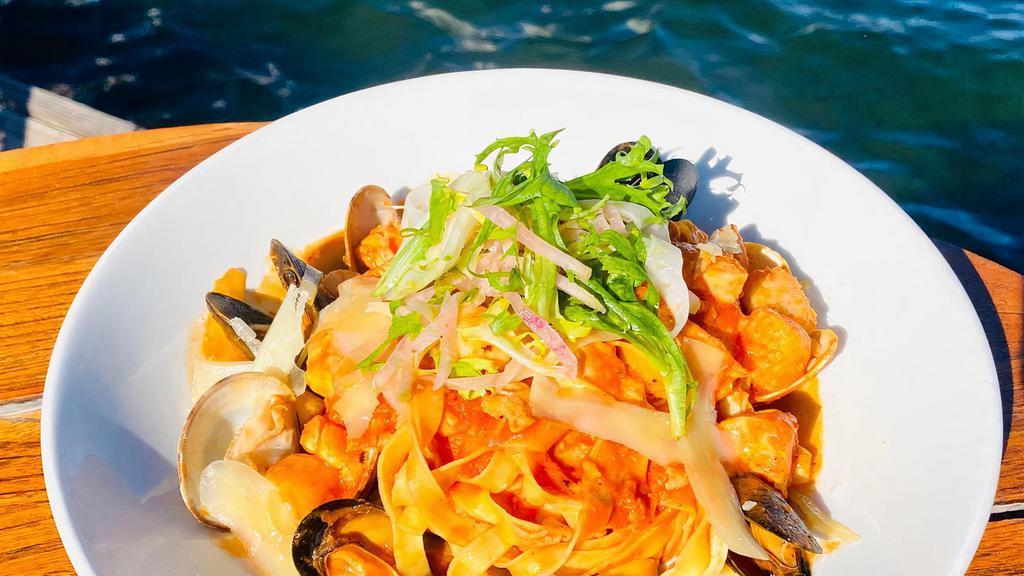 Grand Seafood Linguini · Gulf shrimp, bay scallops, mussels, clams, salmon, calamari, tomatoes, white wine.