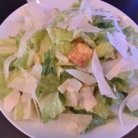 Caesar Salad · Romaine lettuce tossed with homemade Caesar dressing, herb croutons and shaved Parmesan.