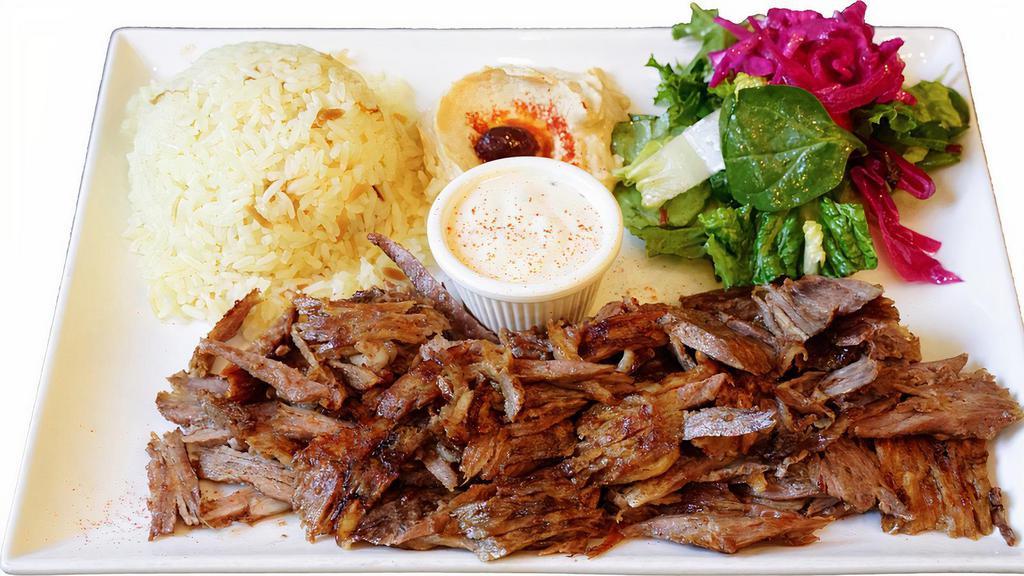 Lamb Beef Gyro Plate · Marinated lamb-beef meat cooked on vertical rotisserie and sliced into thin pieces as it cooks.