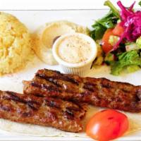 Adana Kebab · Mixer of ground lamb, onions, parsley and spices mounted on a skewer and grilled.