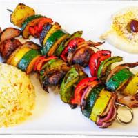 Veggie Skewers · Grilled zucchini, mushrooms, tomatoes and onion served with rice and hummus. (Vegan)