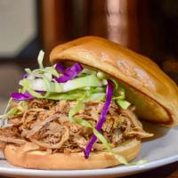Pulled Pork Sandwich · 9 hour house-smoked pulled pork, house-made coleslaw, on a brioche bun, spicy bbq sauce on t...