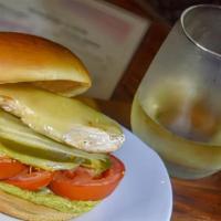 Cali Chicken Sandwich · seasoned chicken breast, pepper jack cheese, avocado dressing, lettuce, tomato, pickles on a...