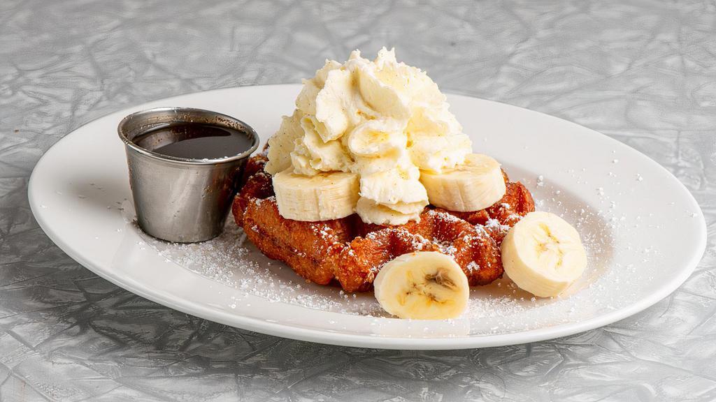 Kid's Waffle · This kids special features a Belgian Waffle topped with Whipped Cream, Powdered Sugar, Fresh Banana slices and Maple Syrup
