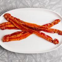 Applewood Smoked Crispy Bacon · Three pieces of crispy bacon