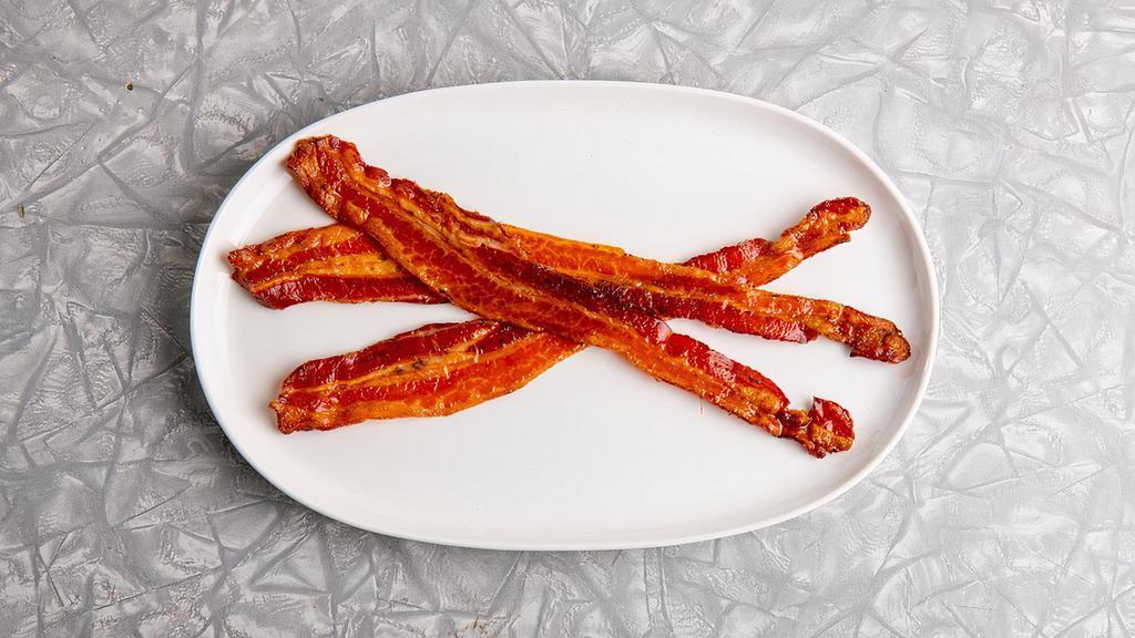 Applewood Smoked Crispy Bacon · Three pieces of crispy bacon