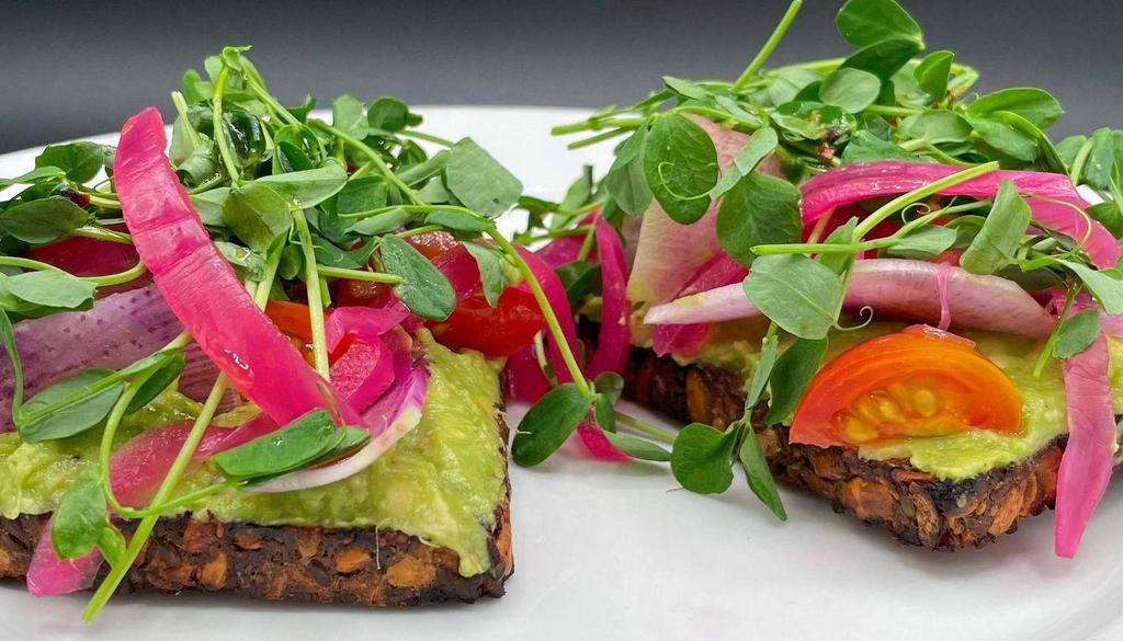 Avocado on Almond & Seed Oat Toast · avocado, lime, chili oil, picked onions, tomato, radish & sunflower sprouts