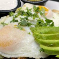 Carnitas & Eggs · Pulled pork, jalapeños, two eggs any style served over corn tortillas & black beans, topped ...