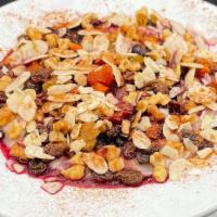 Lily's Oatmeal · Topped with dried fruit medley, warm berry compote, sliced almonds, walnuts & cinnamon
